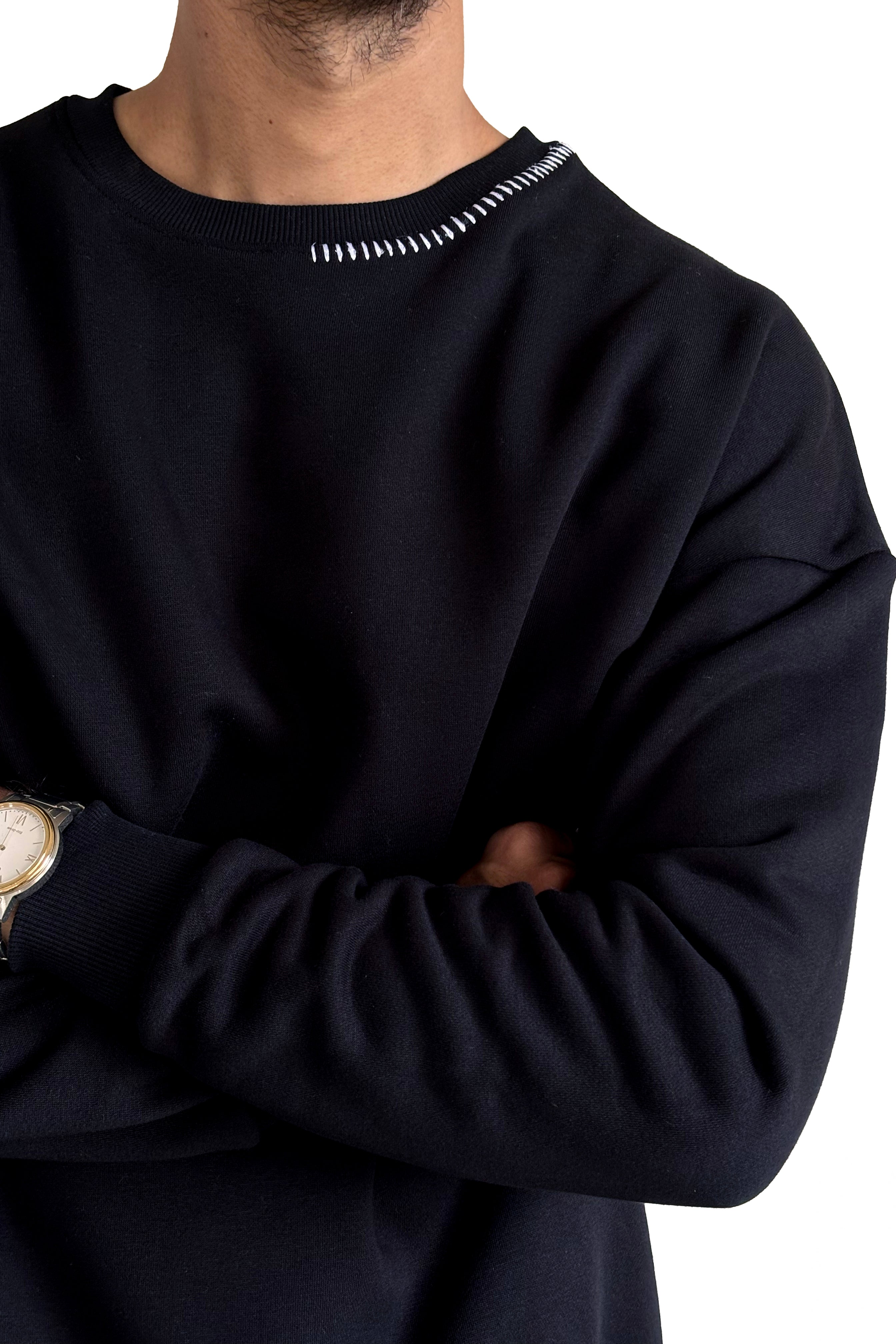 Person wearing a black sweatshirt with a white border on a white background