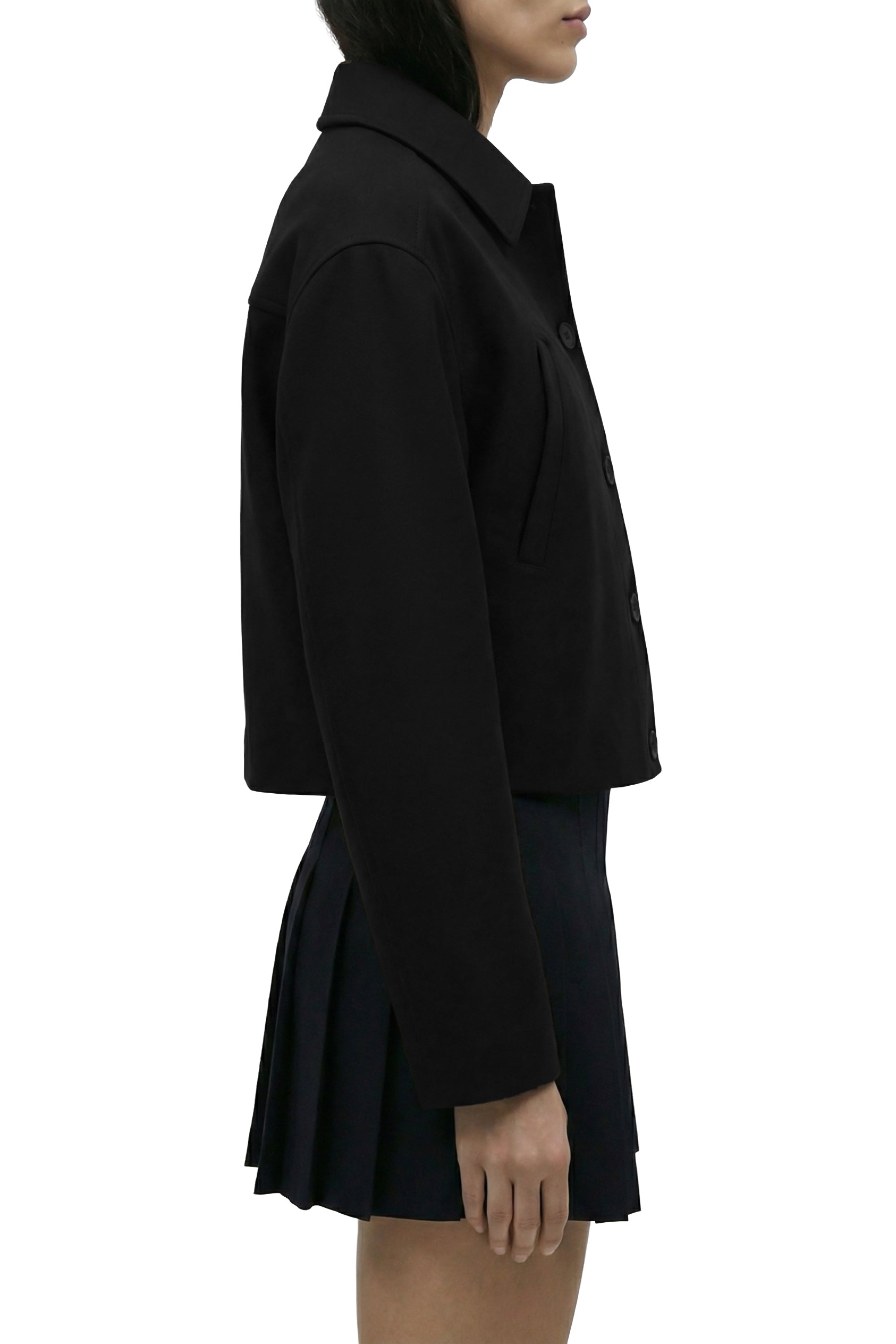 Person wearing a black coat on a white background