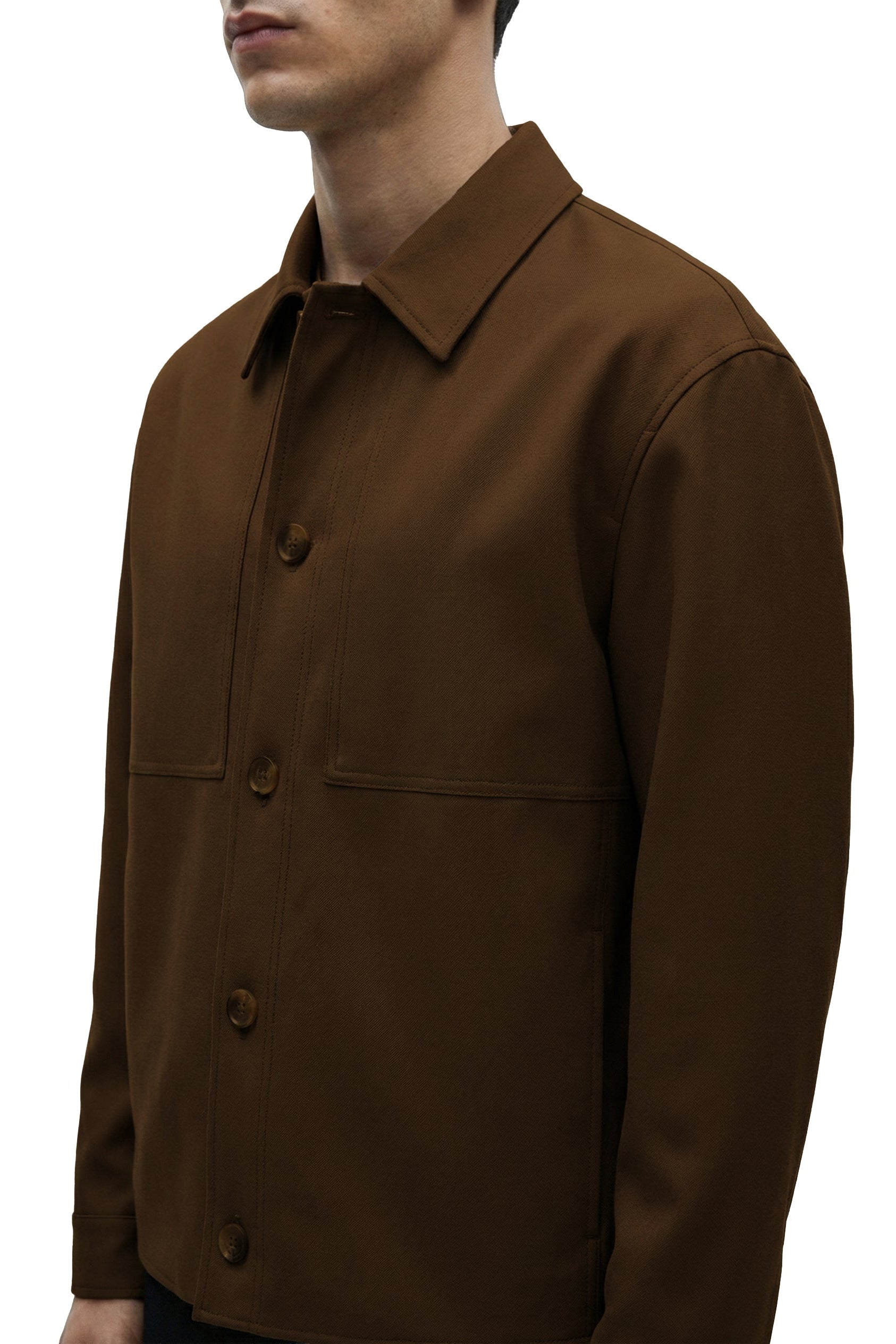 Brown jacket worn by a person on a white background