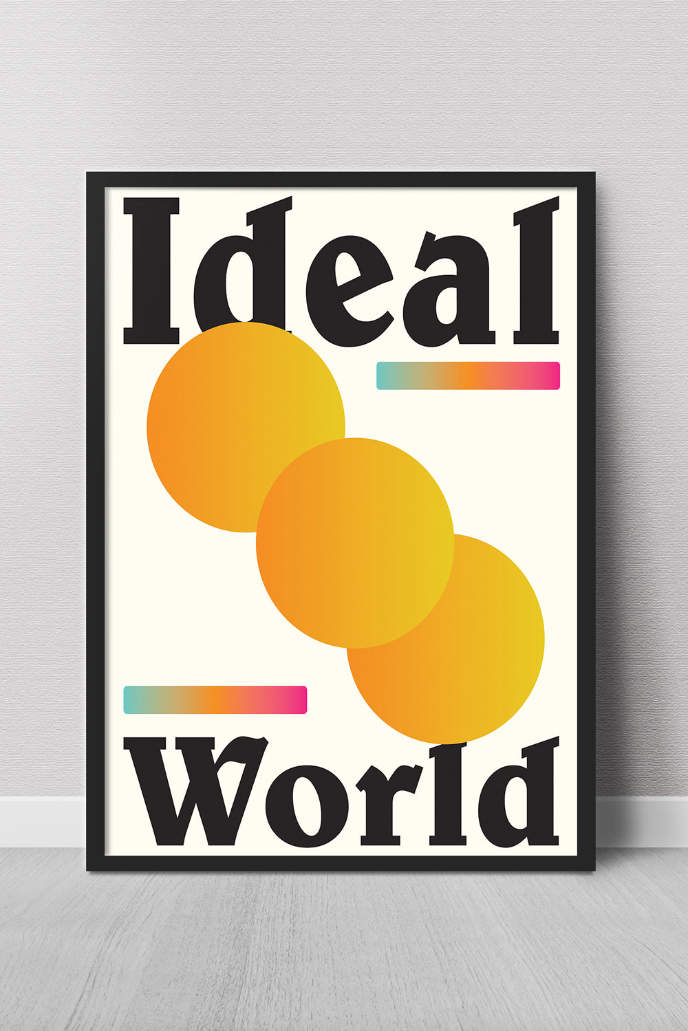 Framed poster with 'Ideal World' text and colorful design on a gray wall.