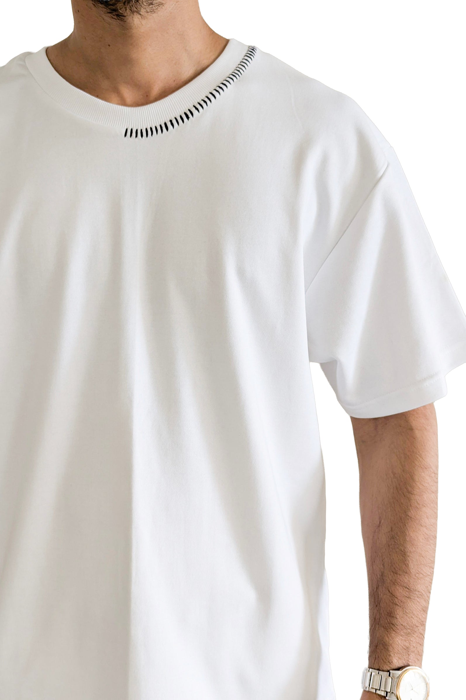 White t-shirt worn by a person on a white background