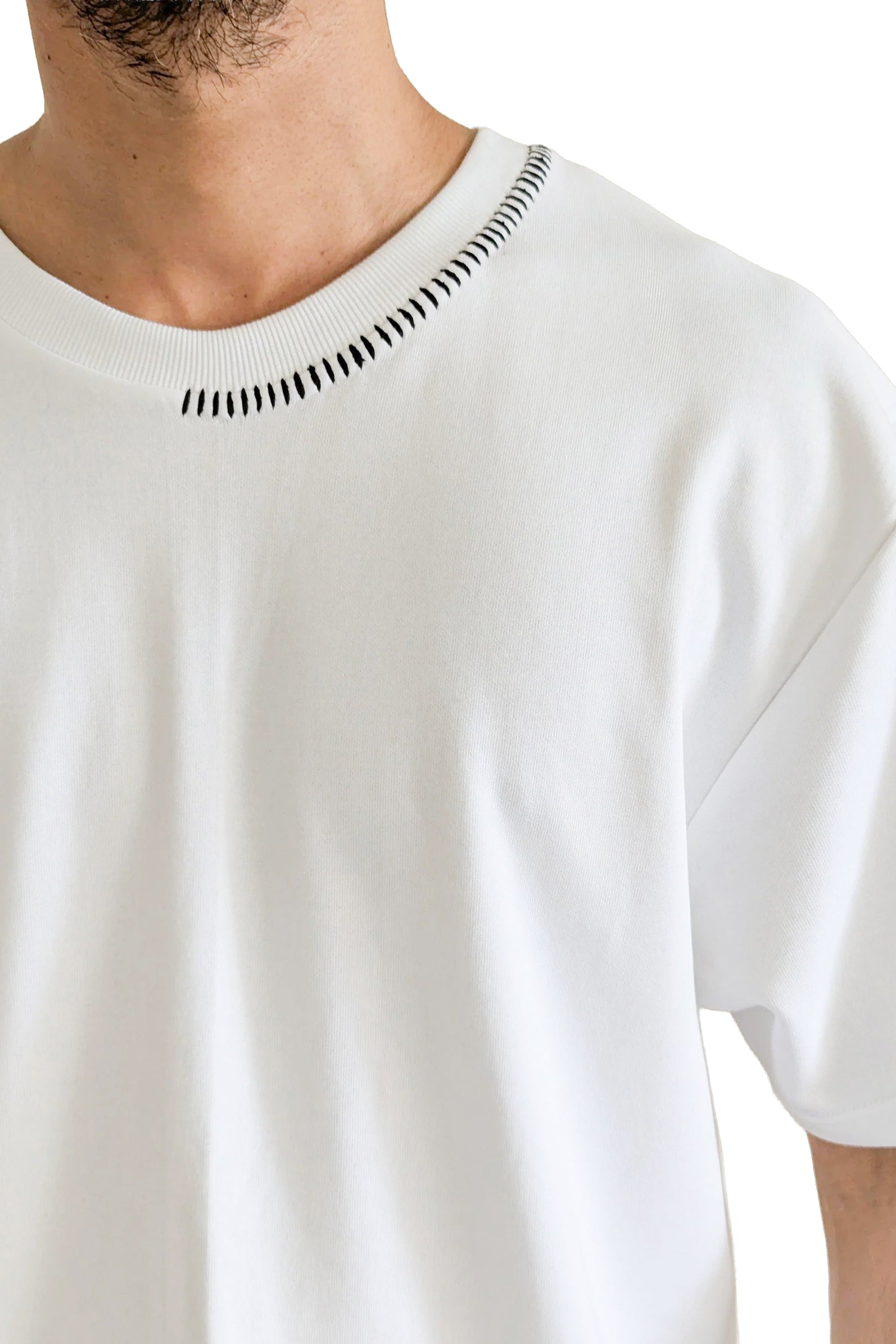 White t-shirt with black decorative stitching on a white background