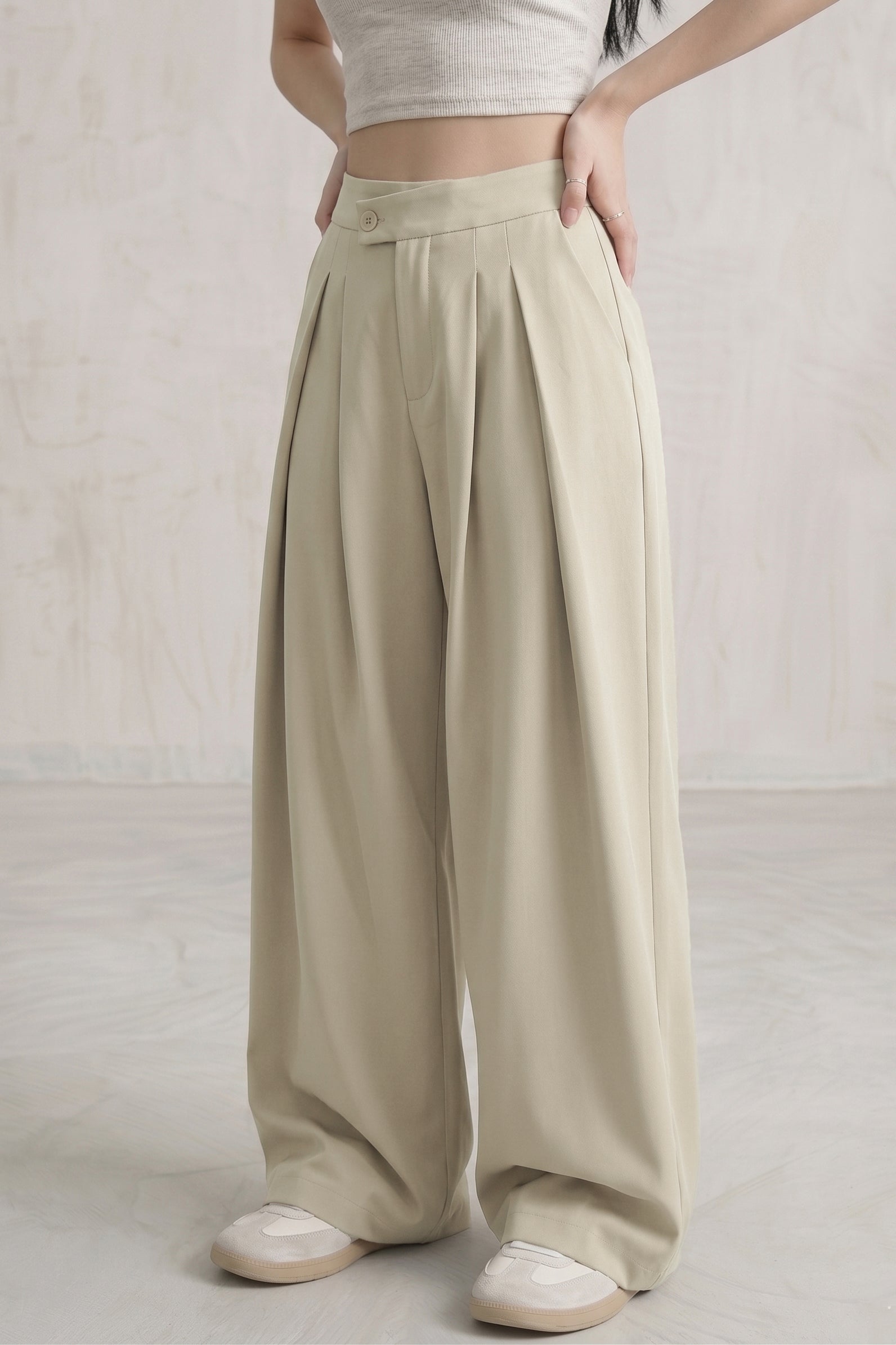 The Maeve Asymmetrical Pleated Trousers — Sage Cream