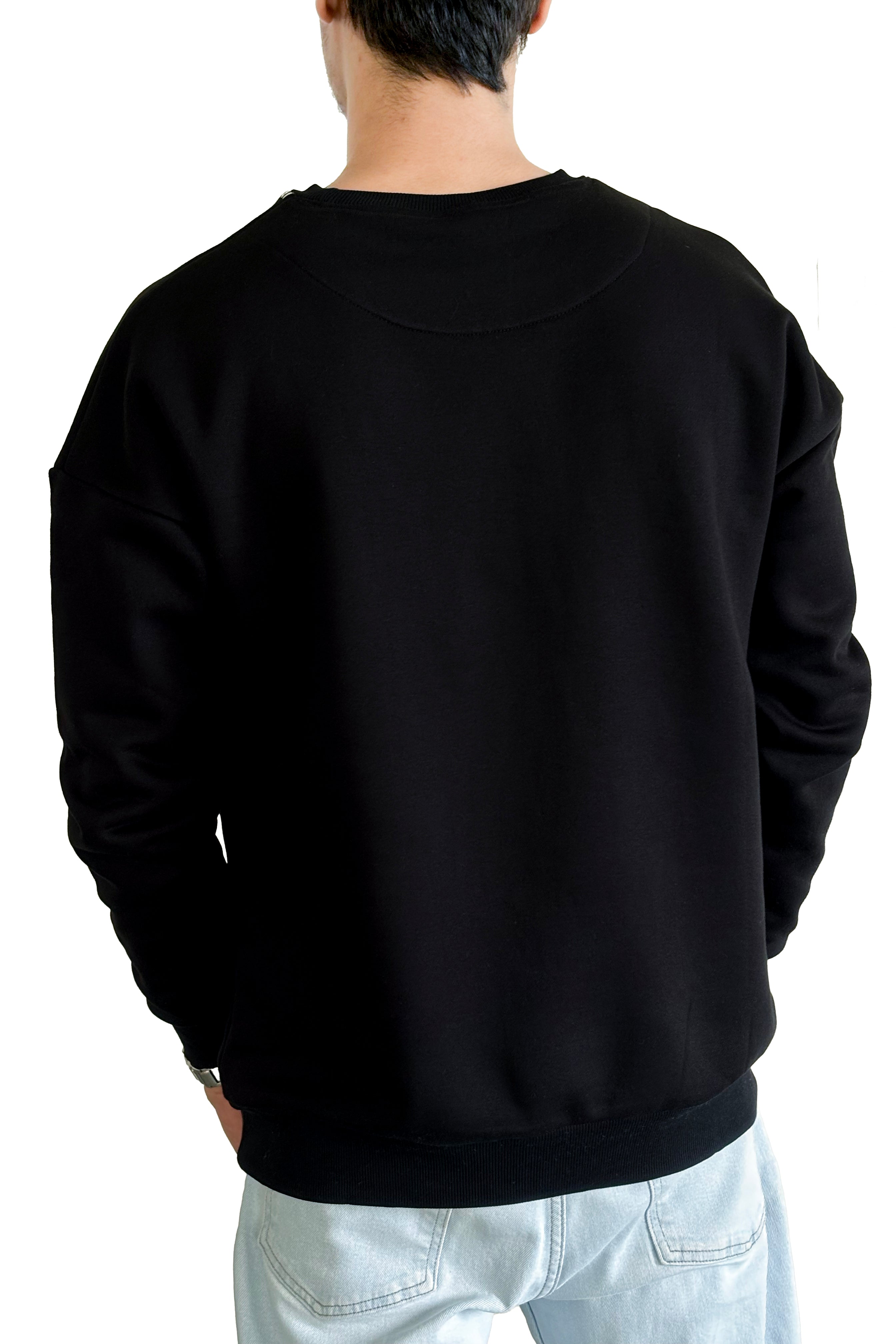 Person wearing a black sweatshirt on a white background