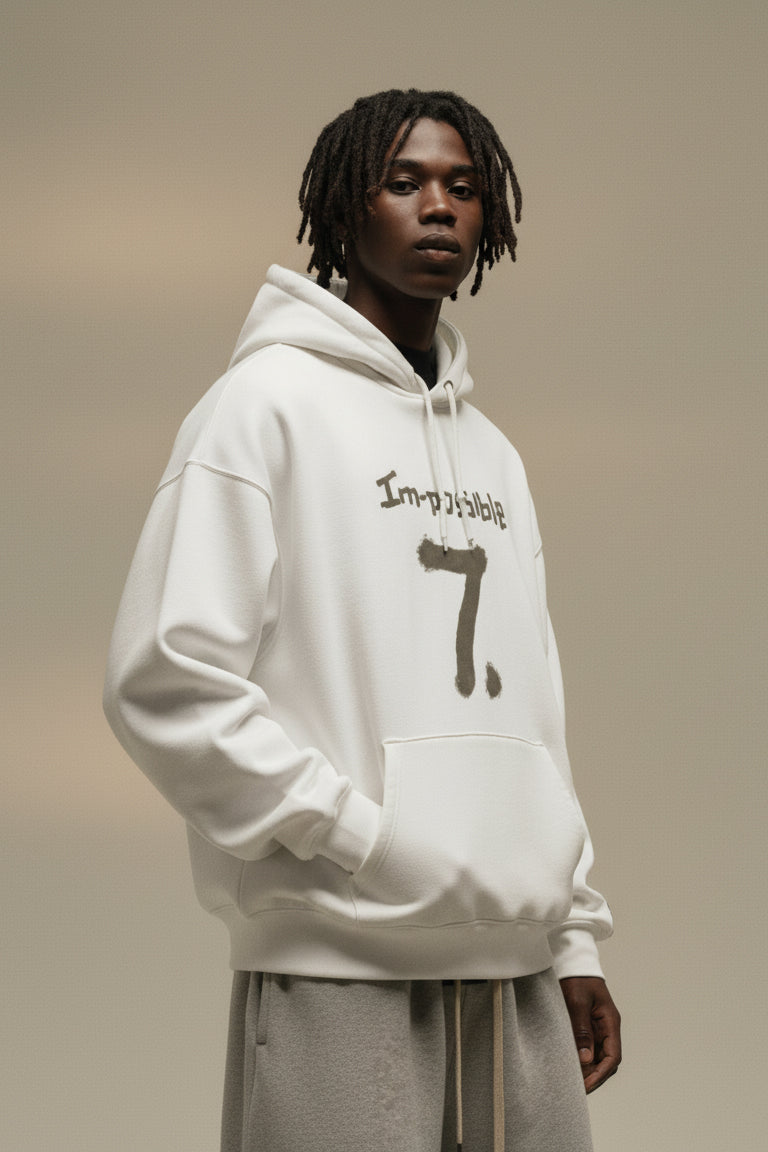 Person wearing a white hoodie with text on a beige background
