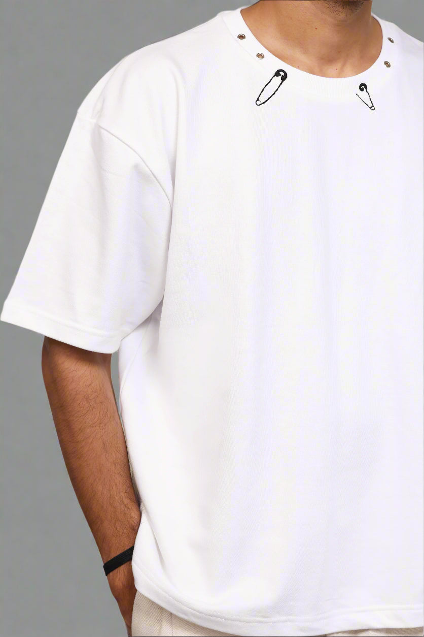 White t-shirt with black button details on a white background