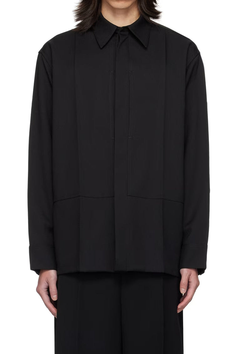 Black shirt worn by a person on a white background