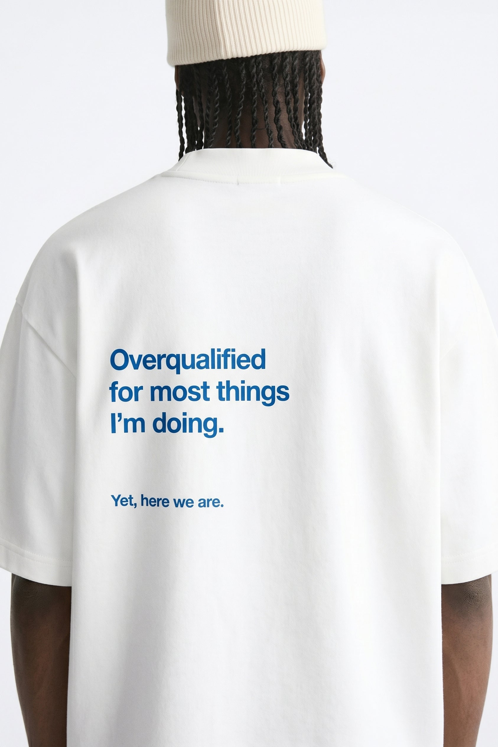 White t-shirt with blue text on the back, displayed on a mannequin against a white background.