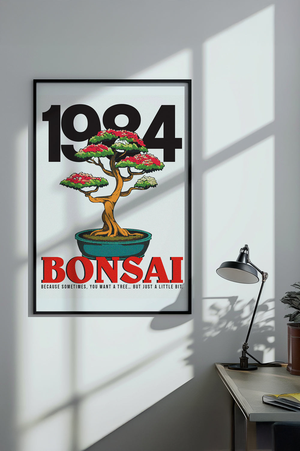 Framed '1984 Bonsai' poster on a wall with a desk and lamp in the background