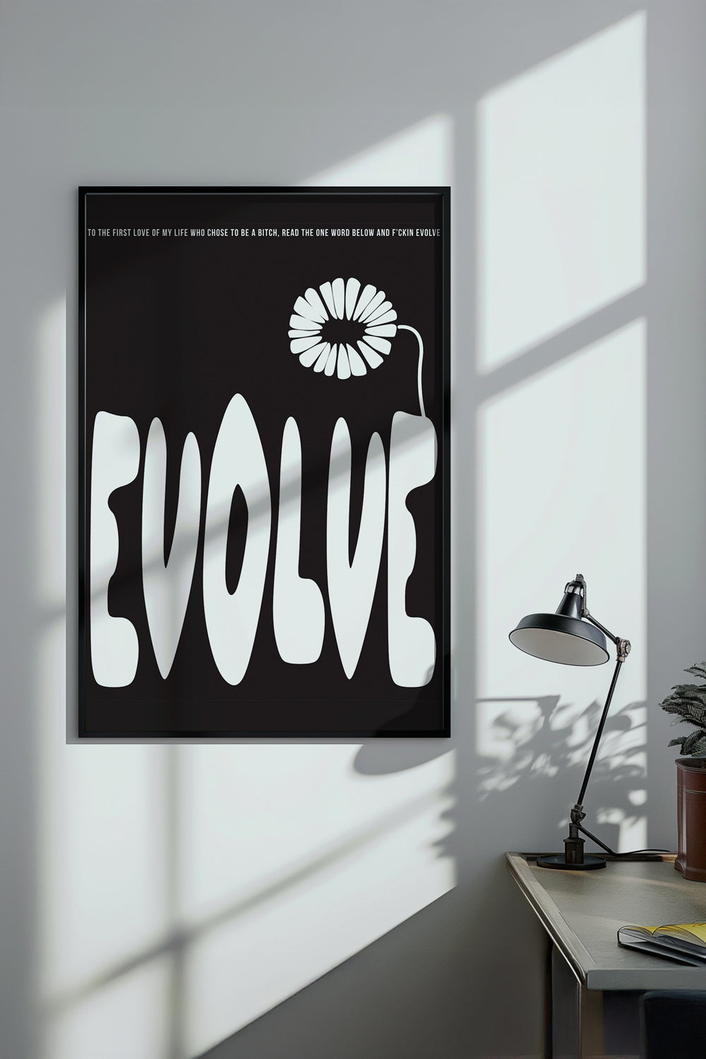 Poster with 'EVOLVE' and a flower graphic on a wall in a room with a desk and lamp.