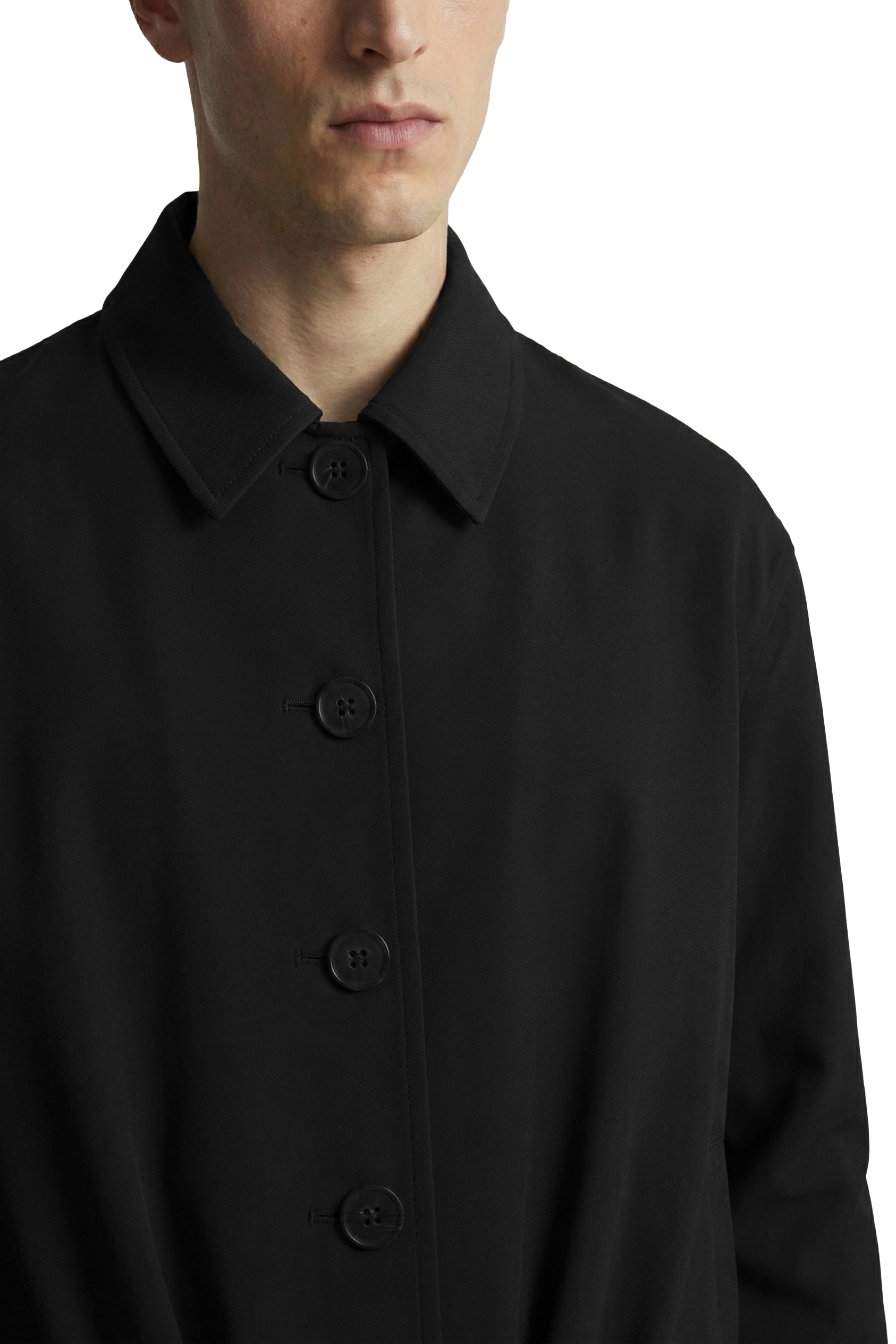 Black coat with button details on a white background