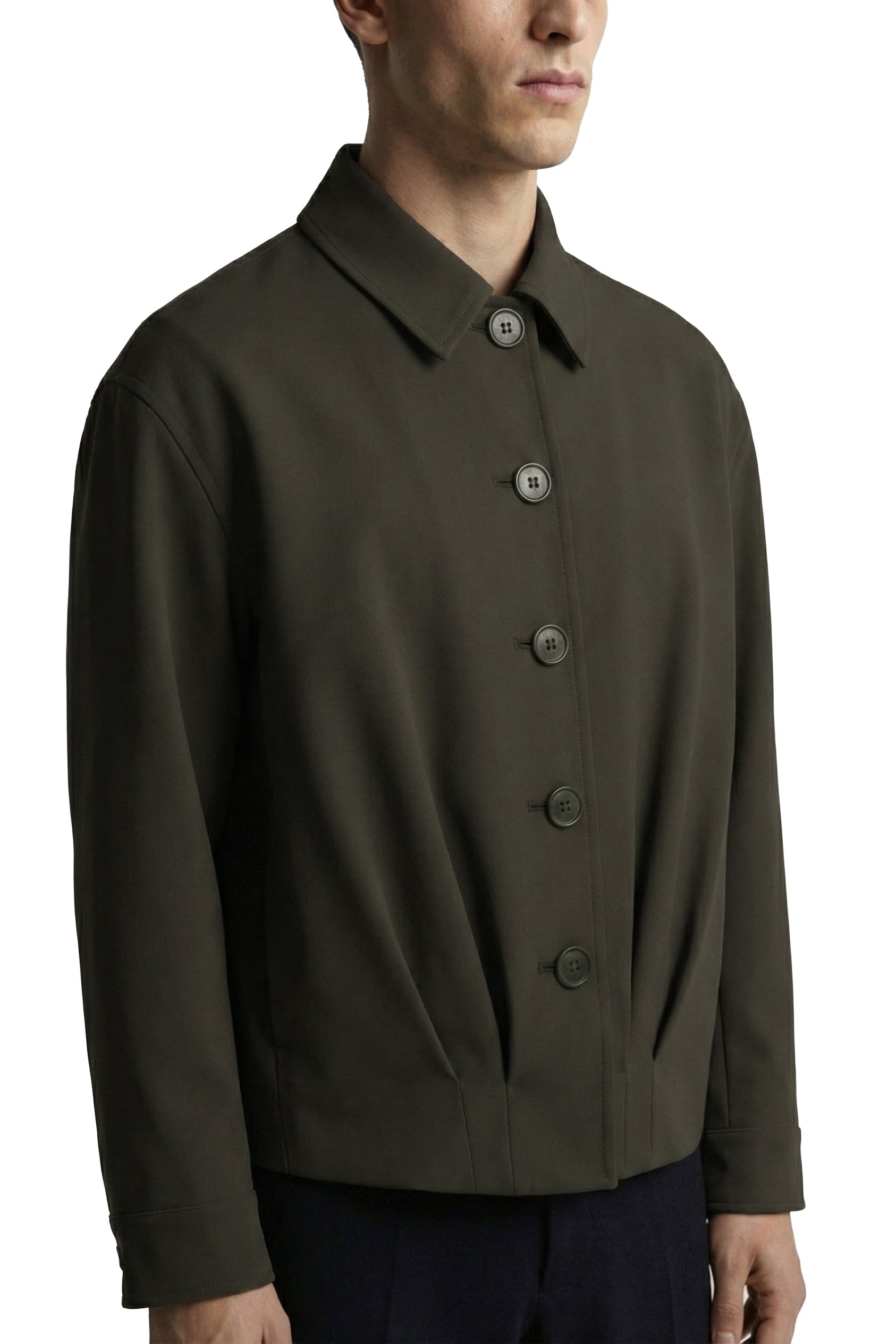 Man wearing a dark green jacket with buttons on a white background