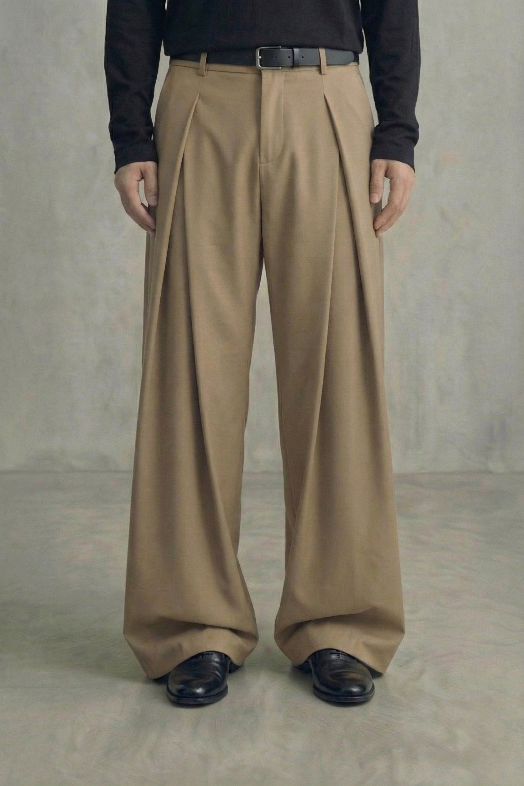 Person wearing beige wide-leg pants against a plain background