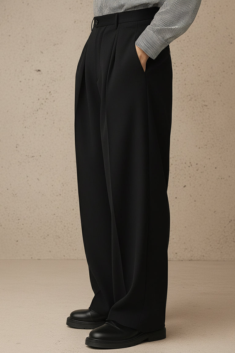 Person wearing black wide-leg pants with a neutral background