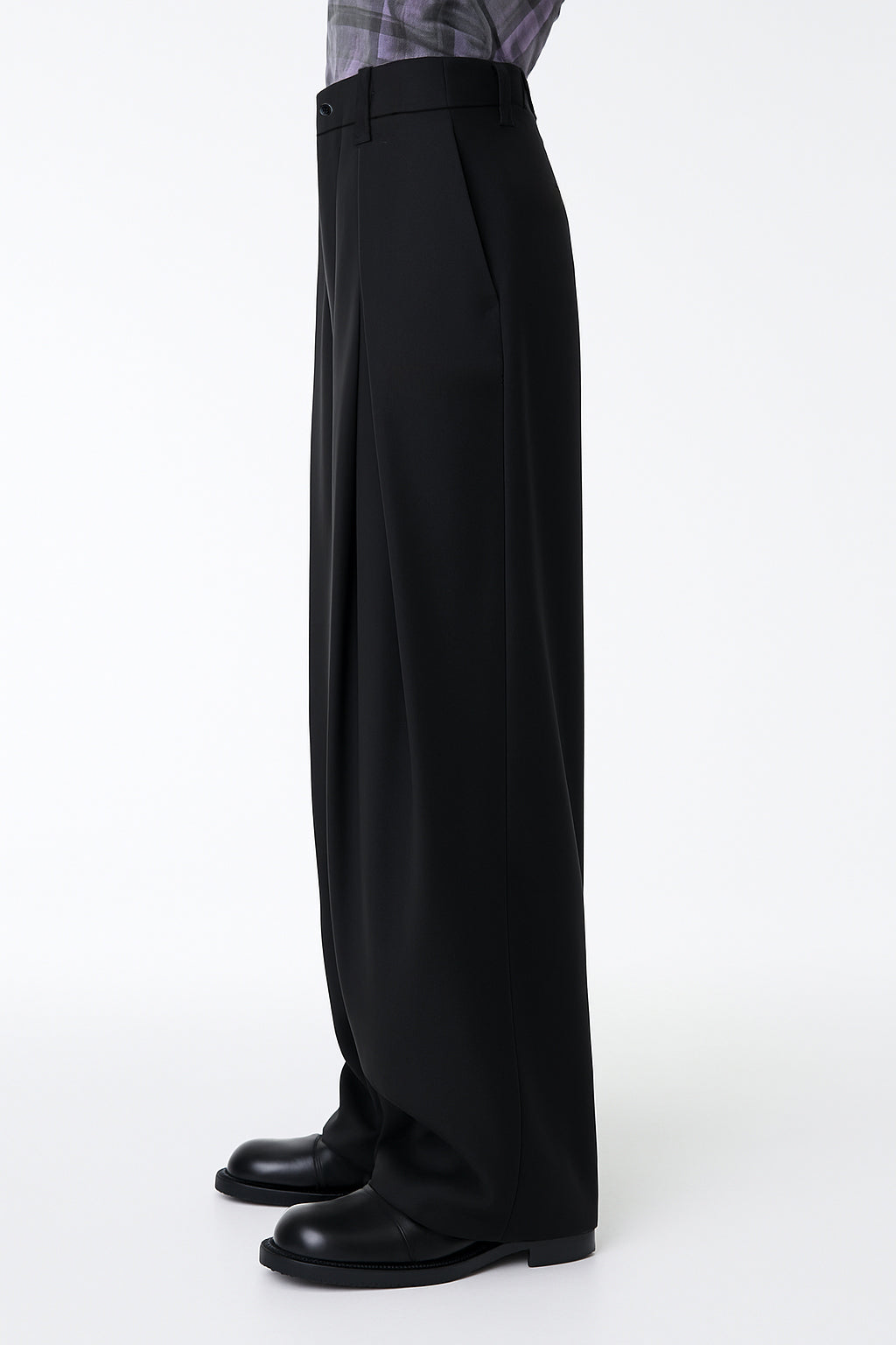 Black wide-leg pants worn by a person on a white background