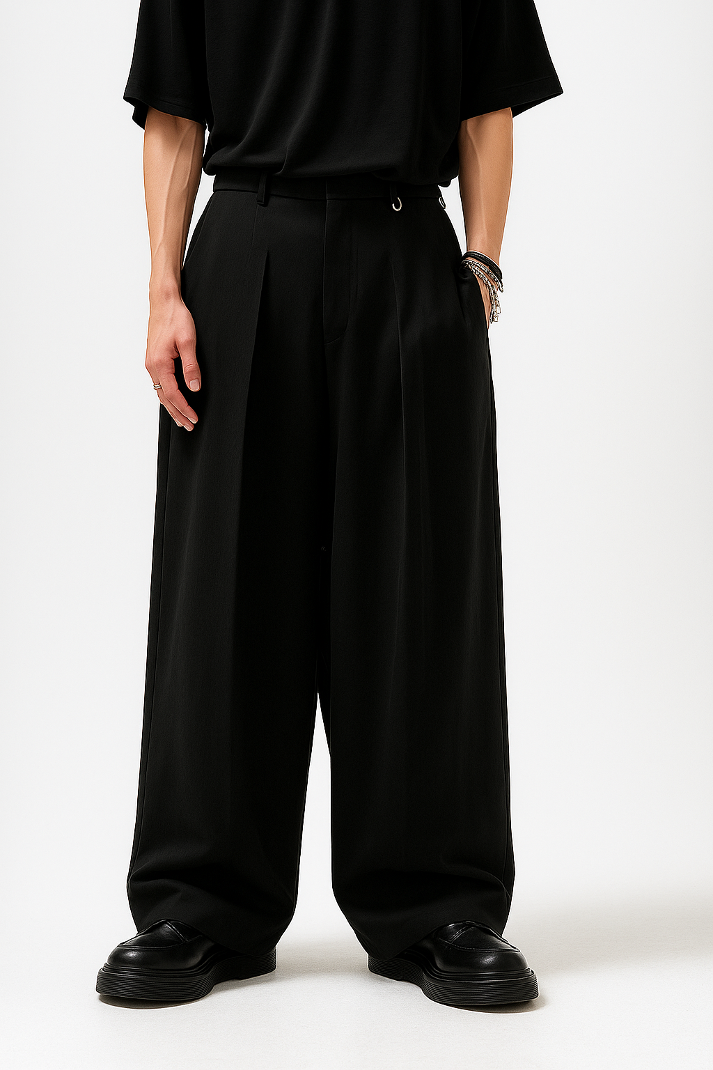 Person wearing a black outfit with wide-leg pants on a white background
