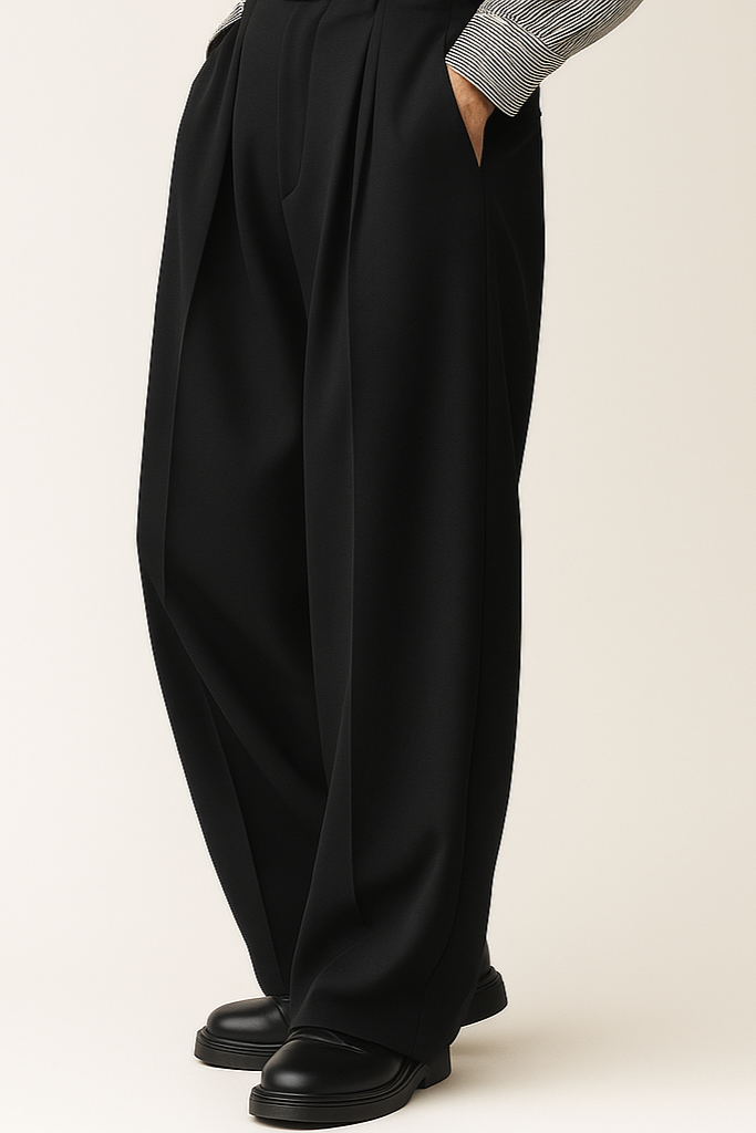 Black wide-leg pants worn by a person on a beige background