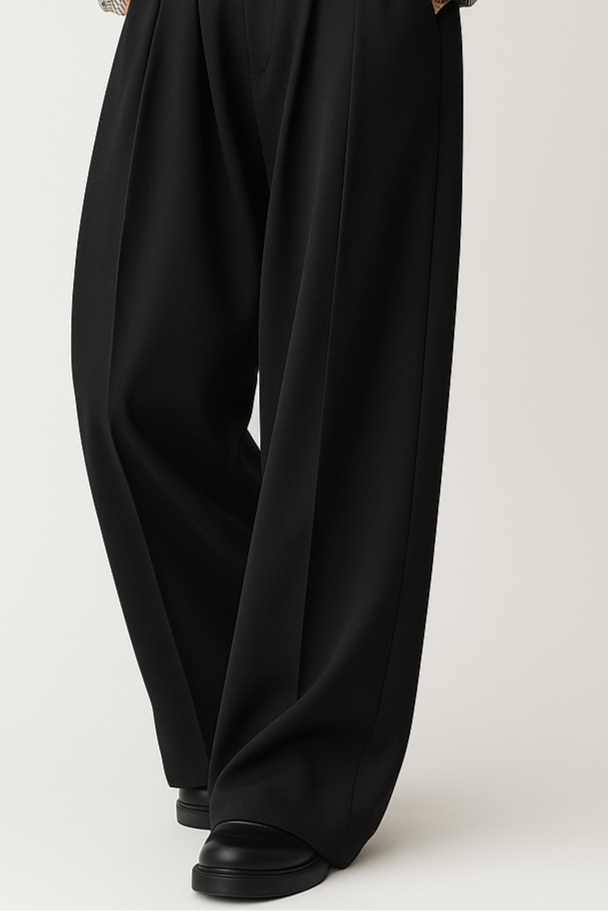 Black wide-leg pants worn by a person on a white background