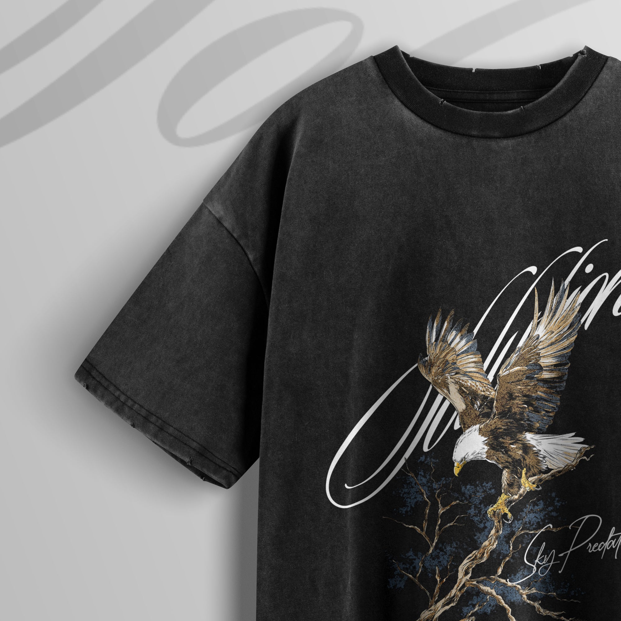 Black t-shirt with an eagle design on a light gray background
