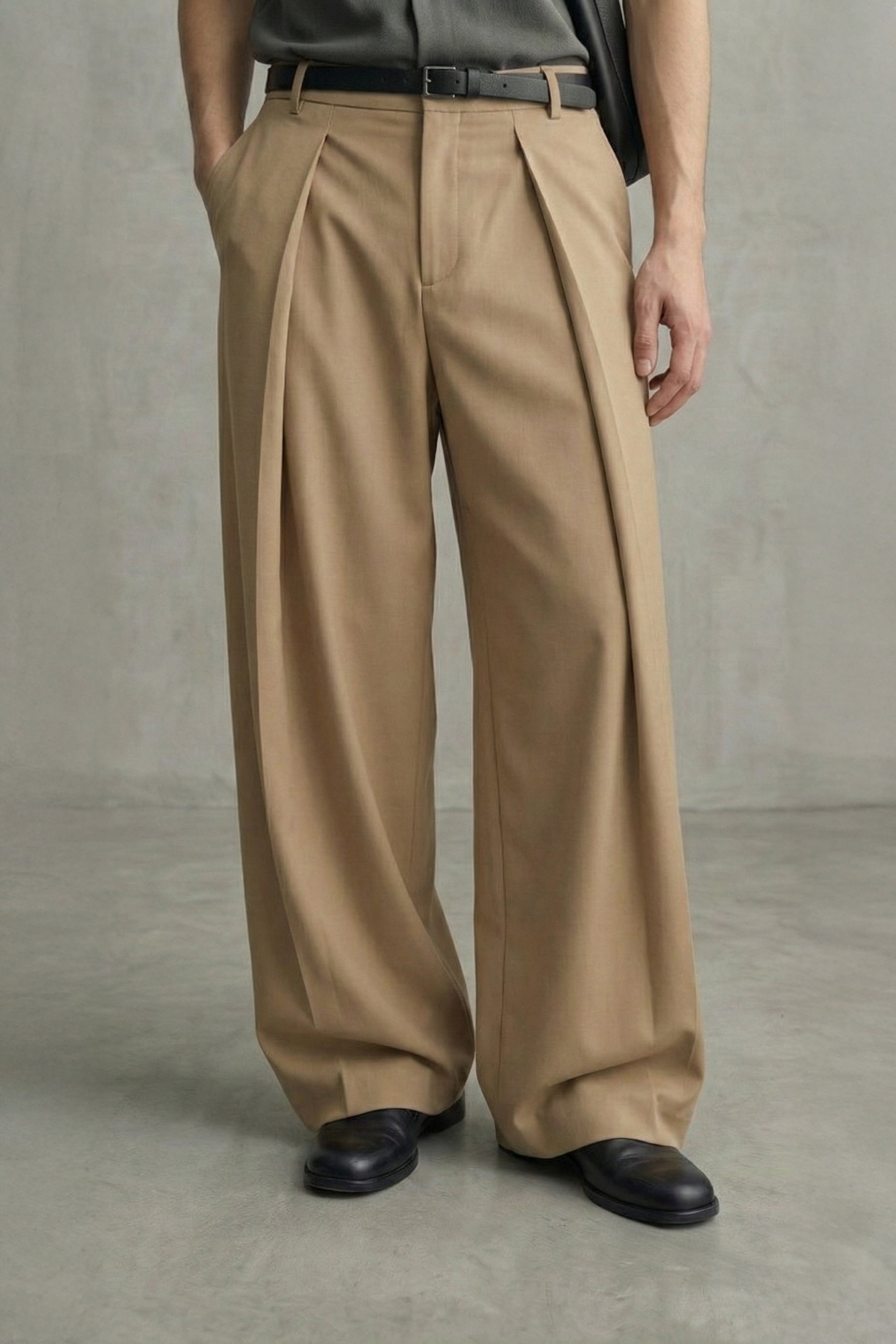 Person wearing beige wide-leg pants against a neutral background