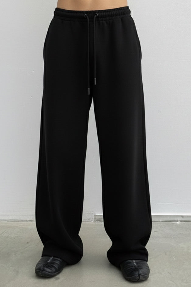 Black wide-leg pants worn by a person on a plain white background