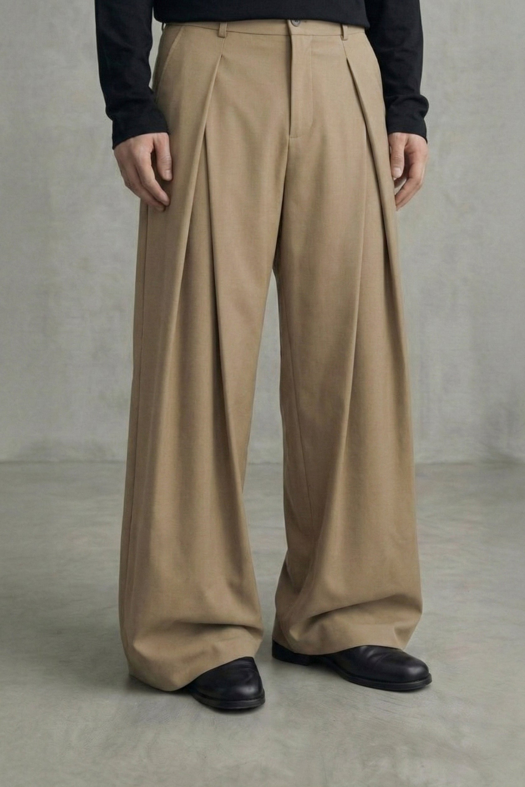 Person wearing beige wide-leg pants against a plain background