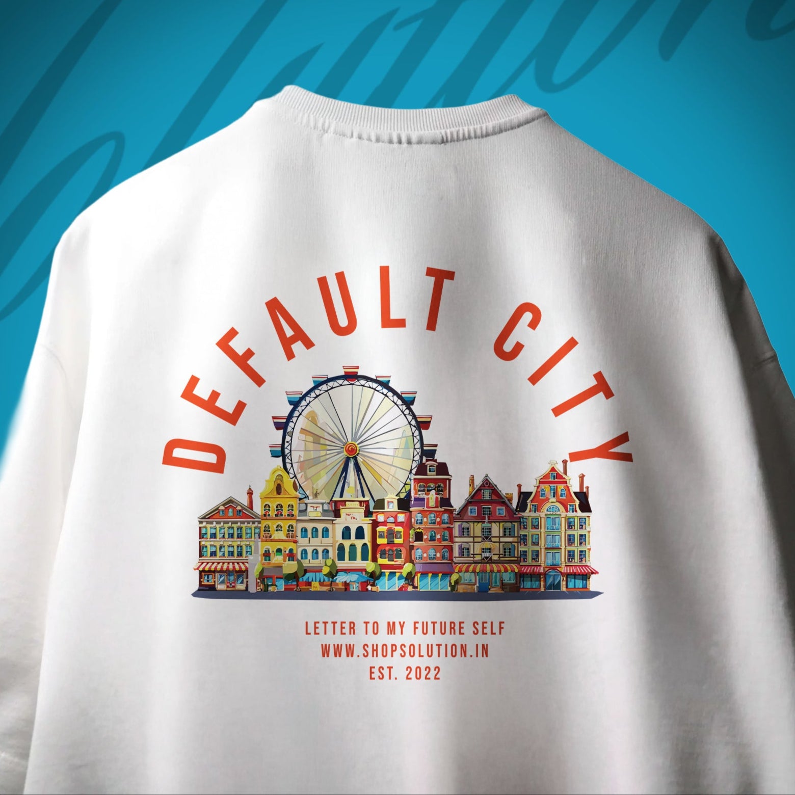 White t-shirt with colorful cityscape design and text on a blue background