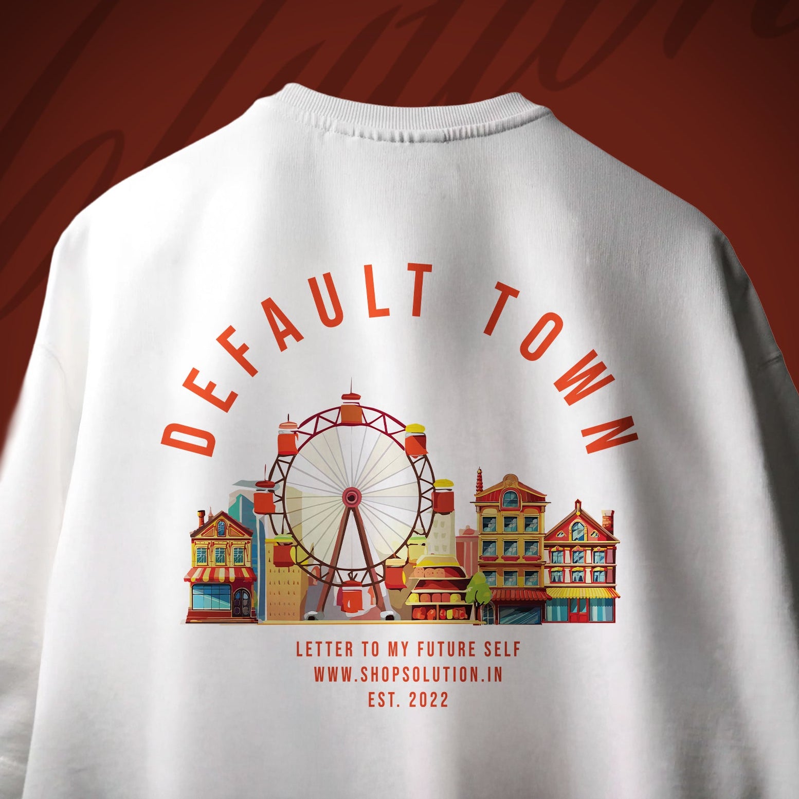White t-shirt with 'DEFAULT TOWN' design featuring a Ferris wheel and buildings on a red background.