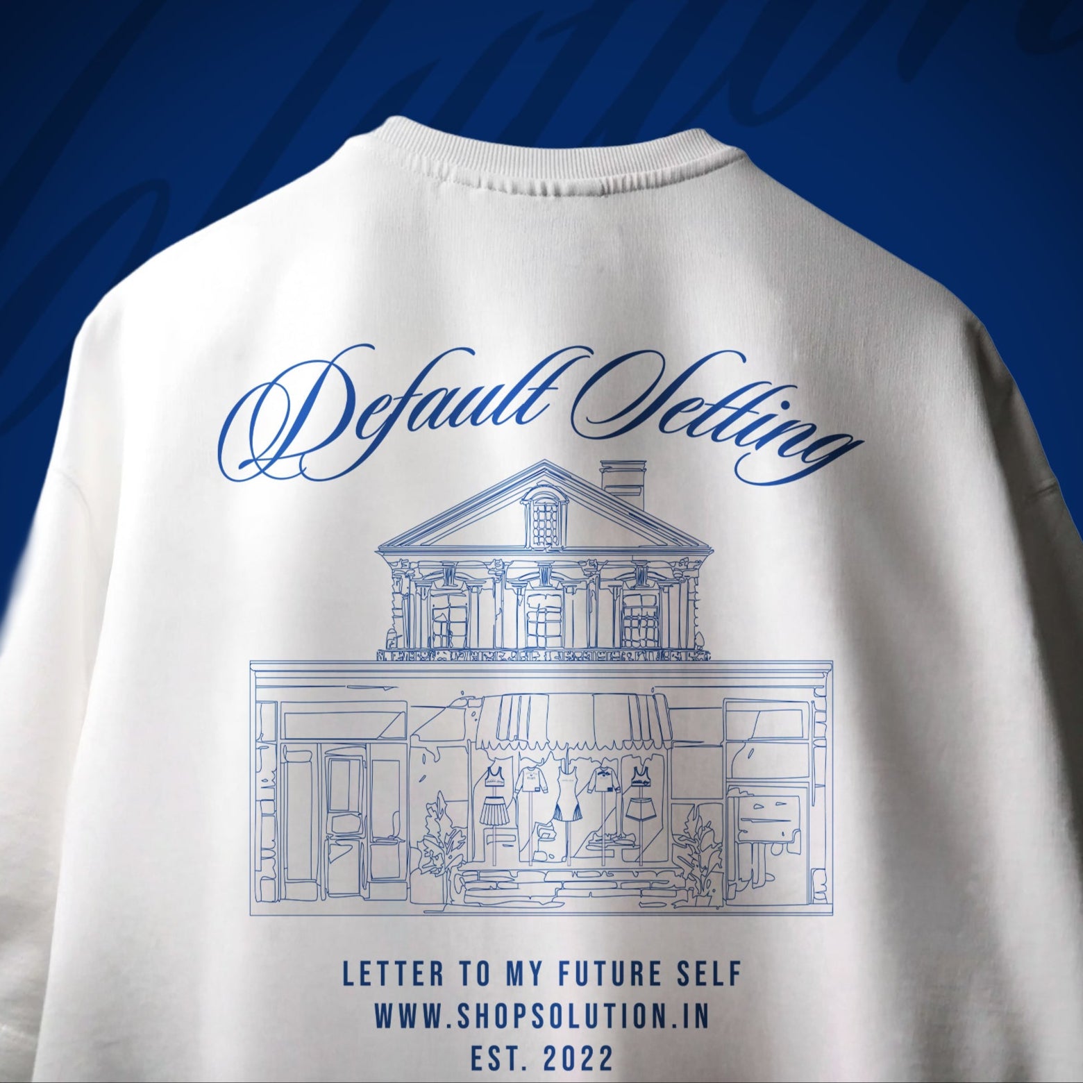 White t-shirt with blue text and building illustration on a blue background